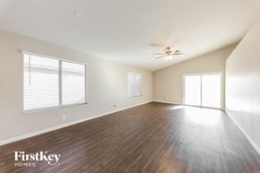 Mesa house for rent - an empty living room with wood floors and a ceiling fan