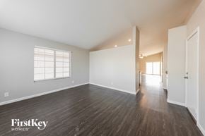 Mesa house for rent - a spacious living room with hardwood floors and white walls