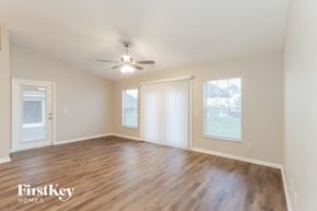 Lakeland house for rent - a living room with wood flooring and a ceiling fan