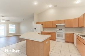 Lakeland house for rent - a large kitchen with wooden cabinets and a white counter top
