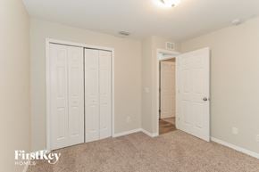 Lakeland house for rent - a bedroom with two closets and a door to a hallway