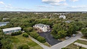 Emerald Isle house for rent - an aerial view of two houses in a neighborhood with trees
