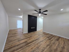 Gary house for rent - a living room with a ceiling fan and a door