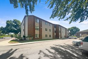 Foley apartment for rent - A row of apartment buildings with cars parked in front.
