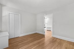 Hamden apartment for rent - A room with a wooden floor and white walls.