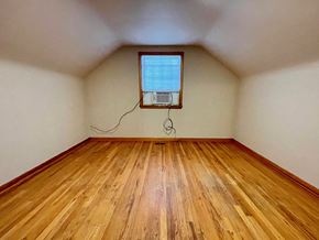 New Albany house for rent - A room with wooden flooring and a window with a view of the sky.