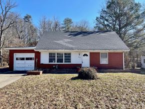 New Albany house for rent - A red and white house with a grey roof and a white garage door.