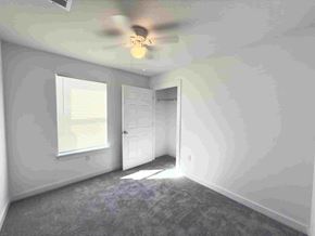 San Antonio apartment for rent - a bedroom with white walls and a ceiling fan