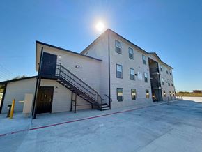San Antonio apartment for rent - the front of a building with the sun shining on it