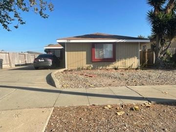 Santa Maria house for rent - A house with a brown roof and a car parked in front.