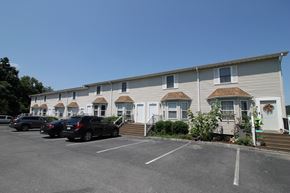 Jonesborough apartment for rent - A row of houses with cars parked in front.