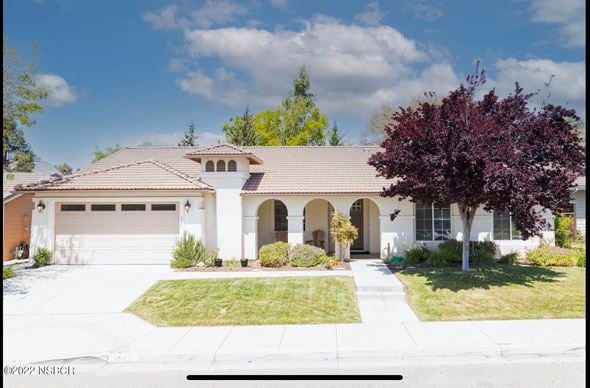 Santa Maria house for rent - A house with a brown roof and white walls with a tree in front.