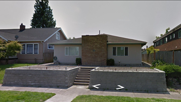Tacoma apartment for rent - A house with a grey roof and a brown brick chimney.
