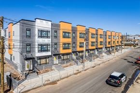Newark apartment for rent - A row of modern townhouses with orange and grey accents.