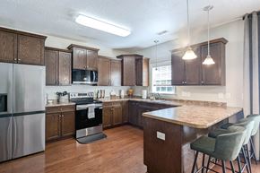 Hubert house for rent - a kitchen with a large island and a stainless steel refrigerator