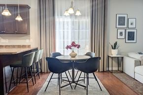 Hubert house for rent - a dining room with a table and chairs and a window