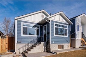 Calgary apartment for rent - A blue house with a white door and windows.