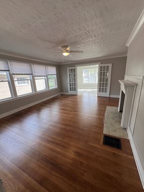 Indianapolis apartment for rent - an empty living room with wood floors and a ceiling fan