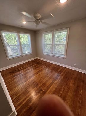 Indianapolis apartment for rent - a living room with wood floors and a ceiling fan