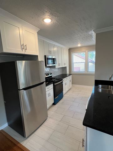 Indianapolis apartment for rent - a kitchen with stainless steel appliances and white cabinets