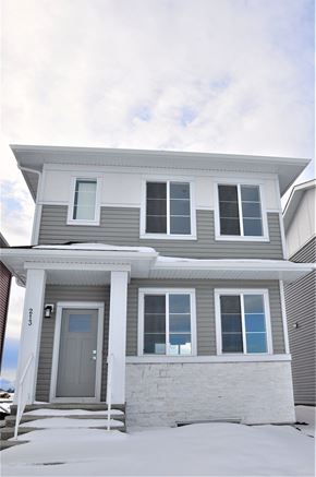 Chestemere house for rent - A house with a grey front and a grey door.