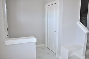 Chestemere house for rent - A white bathroom with a toilet and sink.