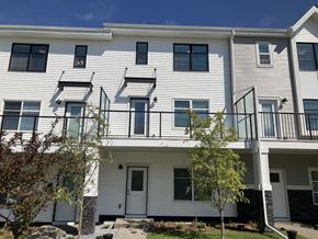 Calgary house for rent - an apartment building with white siding and balconies