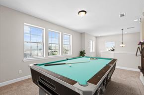 Richmond house for rent - A pool table in a room with a carpeted floor and a window.