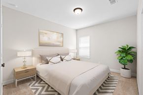 Richmond house for rent - A bedroom with a large bed and a painting on the wall.