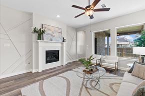 Richmond house for rent - A modern living room with a fireplace and a ceiling fan.