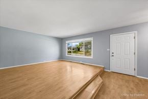 Country Club Hills house for rent - a living room with wood flooring and a window