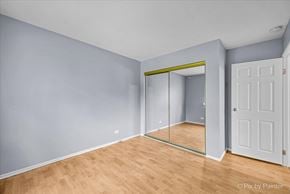 Country Club Hills house for rent - a room with a mirror and a wooden floor and a closet