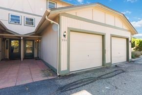Lakewood house for rent - the front of a white house with two white garage doors