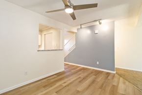 Lakewood house for rent - the living room and dining room of an apartment with wood floors and a ceiling fan