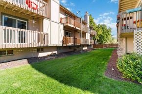 Lakewood house for rent - a view of the back of a building with a lawn