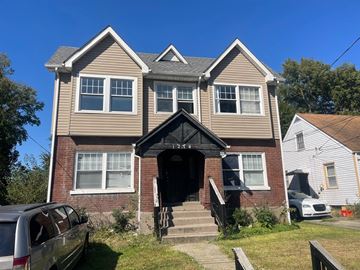 Louisville apartment for rent - A two-story house with a grey roof and a black front door.