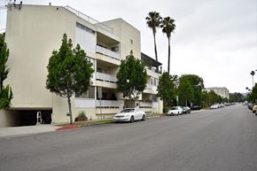 Beverly Hills apartment for rent - an apartment building on a street with cars parked in front of it