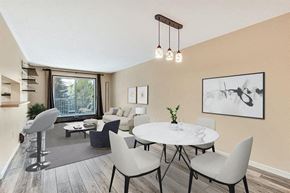 Calgary house for rent - A modern dining room with a round table and grey chairs.