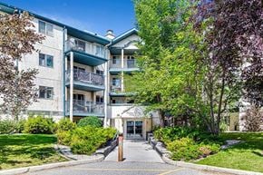 Calgary house for rent - A building with a green lawn in front of it.