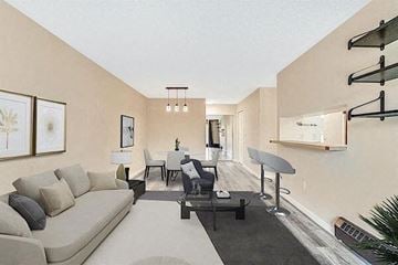 Calgary house for rent - A living room with a grey couch and a black coffee table.