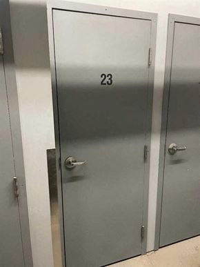 Calgary house for rent - A metal door with the number 23 on it.