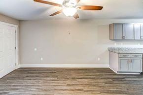Youngsville apartment for rent - A room with a ceiling fan and a kitchenette.