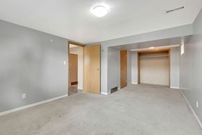 Calgary apartment for rent - a empty living room with a door to a closet