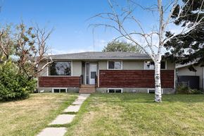Calgary apartment for rent - a house with a sidewalk in front of it