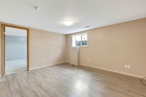 Calgary apartment for rent - a living room with a mirror and a door to a closet