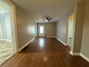 Louisville apartment for rent - A room with wooden floors and a ceiling fan.