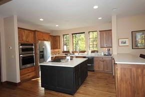 Whitefish house for rent - a large kitchen with a center island and stainless steel appliances