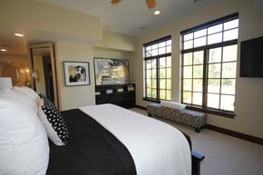 Whitefish house for rent - a bedroom with a large bed and windows