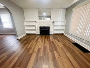 Louisville house for rent - A room with wooden flooring and a fireplace.