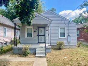 Louisville house for rent - A small house with a grey front and a black door.